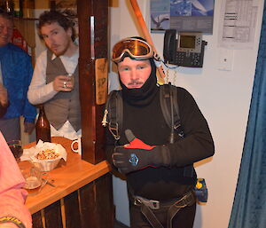 Chris in his scuba gear leaning on the bar on his left is Dave and Aaron