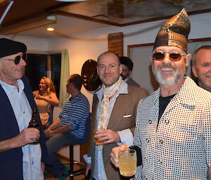 John, Mark and Clive with Nick in the back ground mingling chatting at the bar