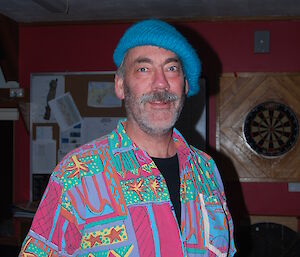 Greg dressed up in a very colourful shirt wearing a beret