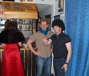 Mike and Tom dressed as French men standing at the bar