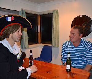 Stephen dressed as Napoléon in a red and white striped shirt talking to Josh dressed in a blues trip top