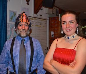 Lionel resplendent in a blue shirt and tie, standing next to Leona in a lovely red gown