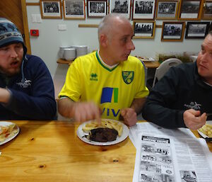 Aaron sitting to the left of Chef Tony who has his diiner with steak and chips and Josh to the right of Chef.