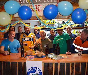 Everybody behind the bar thats’s decorated in yellow and blue balloons and streamers, Craig standing in his blue and yellow Parramatta Eels jersey