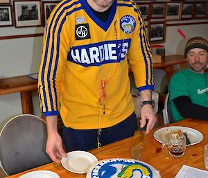 Craig serving a piece of his birthday cake while Marty watches