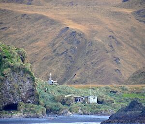 From one of the boats looking towards the beach and Green Gorge hut just above the beach. Tom, Dean and Mike can be seen on the porch of the hut