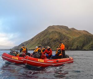 View from one of the boats of the other two boats with the hills rising up from the coast just south of Green Gorge in the background