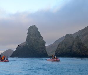 View from one of the boats looking south with the other two boats in the foreground and the rugged rocky outcrops of the Nuggets behind them