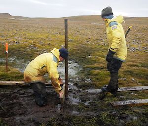 The tall and the short of it. Nick and Chris hard at it constructing a new section of track over some bog. Chris is knee deep in mud while Nick stands by with a sledge hammer in one hand ready to get a sweat up