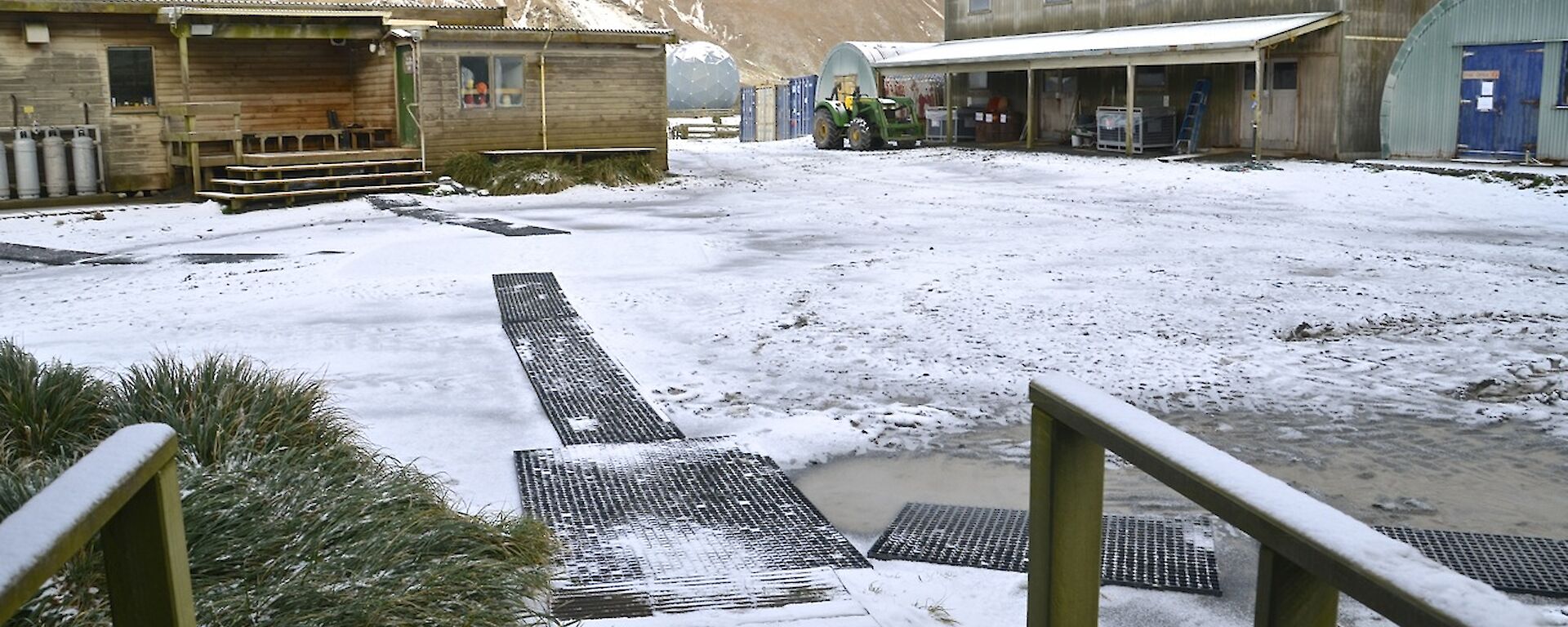 View from Hasselborough House porch last Sunday morning, showing the ground, building roofs and distant hills covered in layer of snow