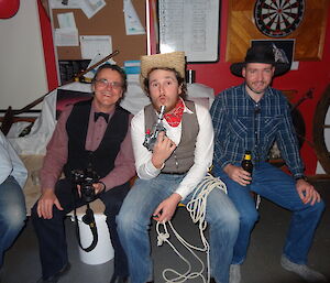 Barry, Aaron and Craig dressed up as cowboys Aaron holding a toy gun