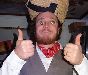 Aaron with bottle top lids as eyes and his cowboy hat