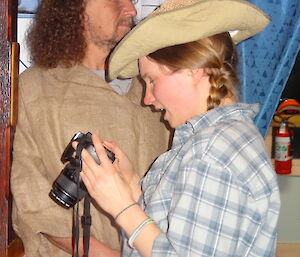 Karen looking at photos on the camera she’s holding she’s dressed up as a cow girl wearing her cowgirl hat