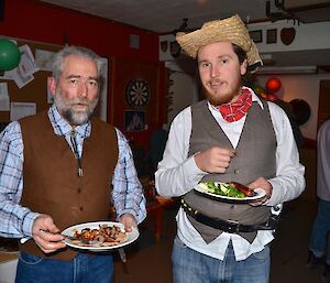 Lionel and Aaron dressed as cowboys enjoying their outback feast