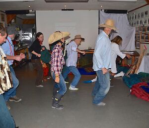Many people dressed in ‘outback’ theme dancing to Nutbush City Limits