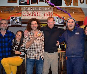 Lionel, Patty, Billy (with some of his finger puppets), Mike Aaron and Karen standing in front of the decorated bar