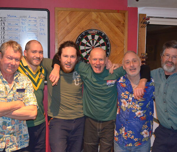 Dave, Craig, Aaron, John, Chef Toy and Clive the winning dart team standing together smilling and proud