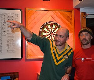 Craig and Marty (absent in the final) stending in front of the dart board after one of the preliminary match