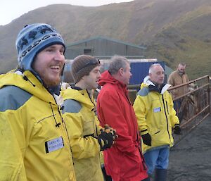 A gathering of some of the station crew for the music videos standing by the gate