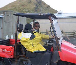 Baz with his back towards the camera filming Dean driving the red buggy