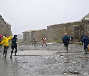 Several expeditioners, armed with a haggis, trying to hurl them at the kilted Dean and Billie