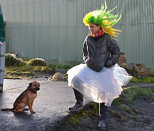 Angel Newport (dressed in a fairy skirt and wearing spiky, green and yellow wig) with her sleek racing machine Cody