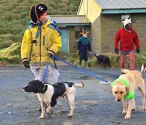 Leona, Nick, Billy and Kaz parading their dogs around the courtyard in front of the mess