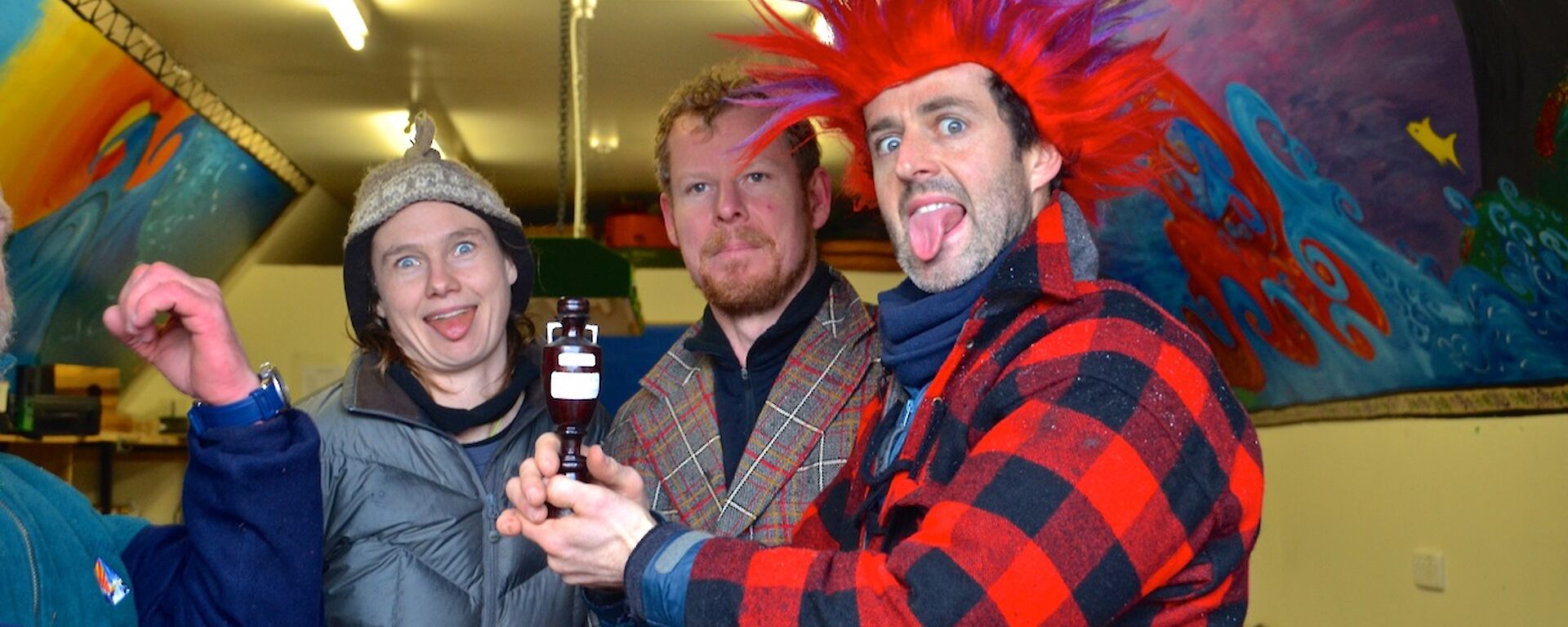 Nick (mostly out of picture) Angela, Mike and Steve (with a red and purple mohawk wig) performing the Haka. Steve is holding the tug-o-war trophy; a replica of the ‘ashes’ urn.