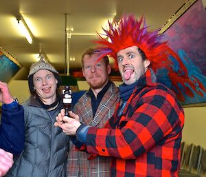 Nick (mostly out of picture) Angela, Mike and Steve (with a red and purple mohawk wig) performing the Haka. Steve is holding the tug-o-war trophy; a replica of the ‘ashes’ urn.