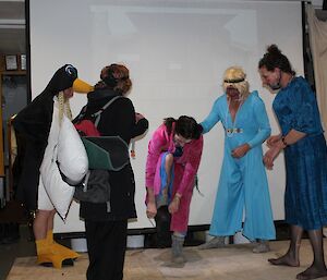 If the shoe fits? The prince lets one of the ugly sisters try on the boot, while Cinderella, the evil step mother and the other sister look on. Poor Cinderella has been turned into a penguin