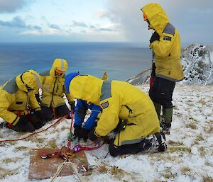 Taken from a snow covered slight slope above Gadgets Gully — part of the ERT rigging the rope system for the stretcher raise