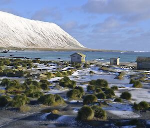 Westward view of the ocean the snow covered hills to the left and one of the magnetic zone huts in the foreground