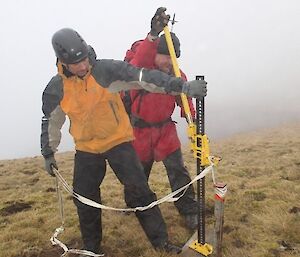 Marty and David using a jack and some rope to remove an old SAR anchor