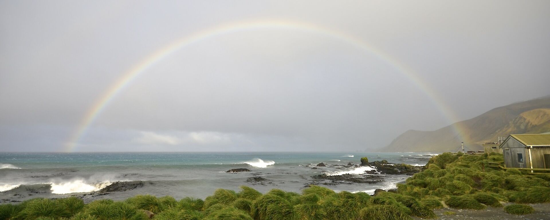 The sun came out for a brief time and gave us this — a full rainbow over the water from East Beach