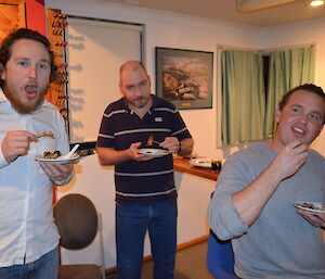 Aaron, Craig and Josh, each with a plate of finger food, enjoying Dave’s birthday party