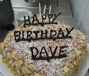 Dave’s birthday cake — a tall cake with ‘Happy Birthday Dave’ letters in chocolate across the top and slivered almond pieces stuck to the side