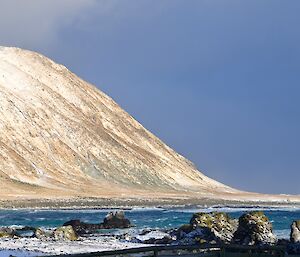 View across Hasselborough Bay to the snow covered slopes and Handspike Point