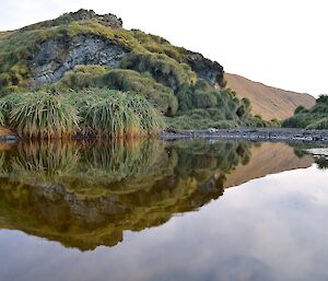 The gap in Razorback Ridge almost perfectly reflected in a puddle on the track