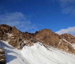 Sellick Bay escarpment after snowfall. The rugged, rocky peaks of the escarpment are exposed (not snow covered)