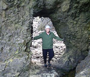 Somewhere on Hurd Point — Josh standing in a tunnel, about two metres high by one and a half metres wide through a jagged rocky wall