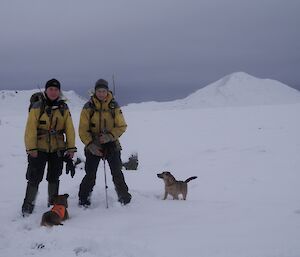 Rat girls, Leona and Ange standing ankle deep in a snow covered scene at Mt Jeffryes. Two of the ‘rat dogs’ are next to them in the snow