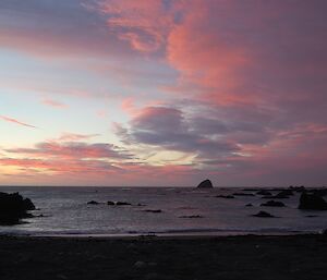 Predominantly pinkish tinged sunset over Hasselborough Bay