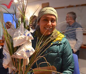 Patty with a bunch of flowers in front of her. It is a collection of grass stems with small bags of flour attached