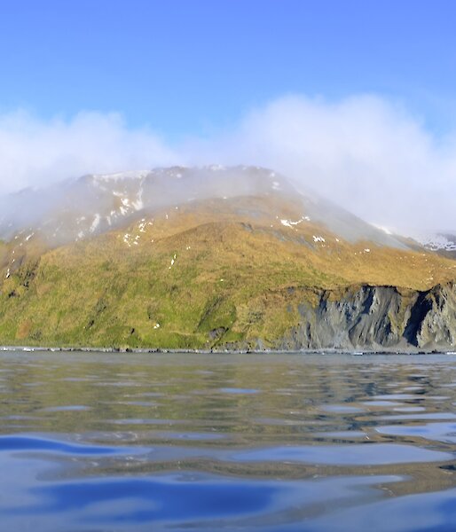 Taken from one of the boats looking across the ‘glassy’ water at the escarpment just south of the Nuggets. There is patches of snow on the slopes and the tops are covered in misty cloud