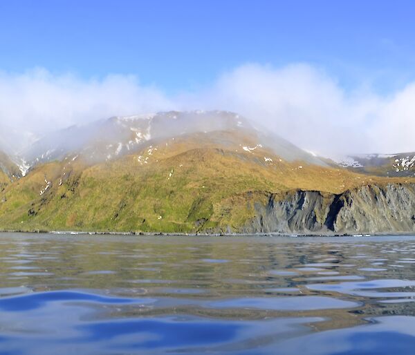 Taken from one of the boats looking across the ‘glassy’ water at the escarpment just south of the Nuggets. There is patches of snow on the slopes and the tops are covered in misty cloud