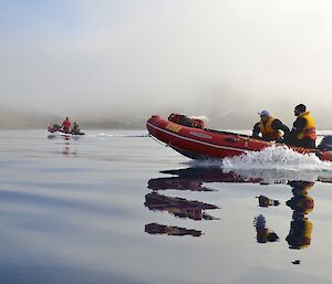 Heading south in perfect conditions — shows two of the boats on the water which is like a mill pond. The boat in the foreground has distorted reflections in the water of the crew — Mark and Josh