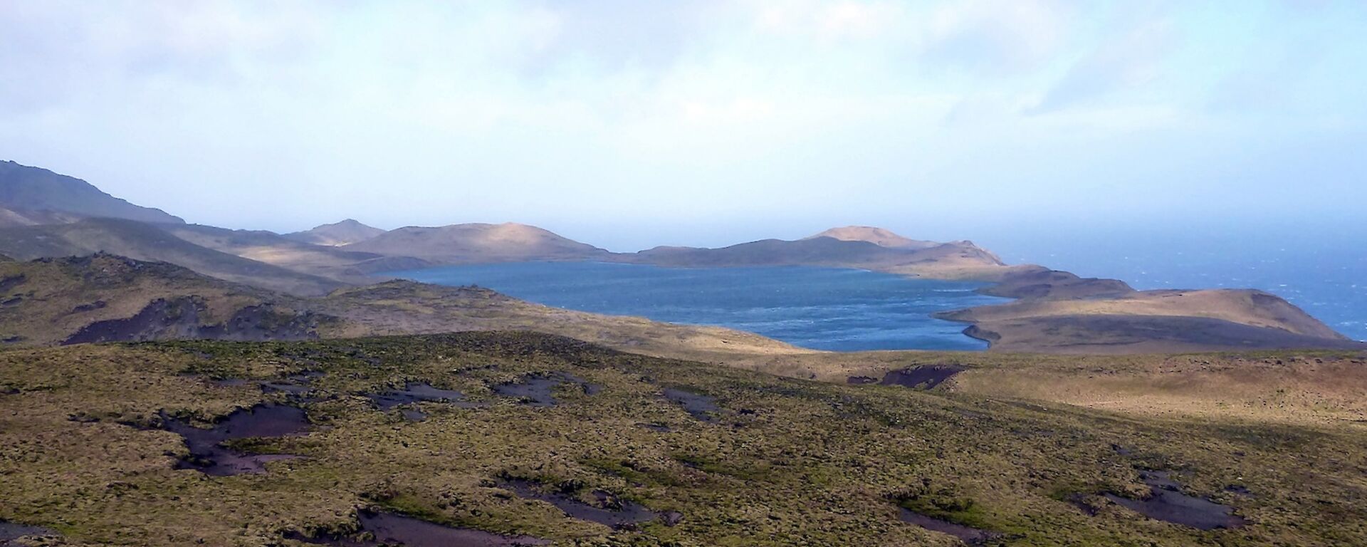 Looking west from the overland track across Major Lake with the ocean visible beyond