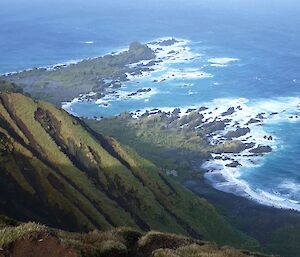 Looking down from a high vantage point on the edge of the grassy jump up at Hurd Point. The hut can be seen way below just up from the beach and Hurd Point can be seen poking out into the Southern Ocean