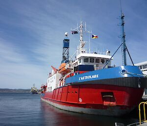 L'Astrolabe, brightly painted red, white and blue, tied up at the wharf just prior to departure form Hobart