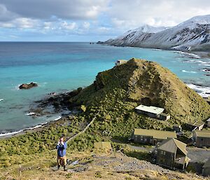 View to the south from the ‘golf tee'. Tom, one of the MIPEP crew is just down the slope. Part of the station can be seen in the bottom right with Camp Hill and the Ham Shack in the middle lit up by the sun. The snow covered east coast escarpment i sin the right background while the ocean has amazing shades of blue colour